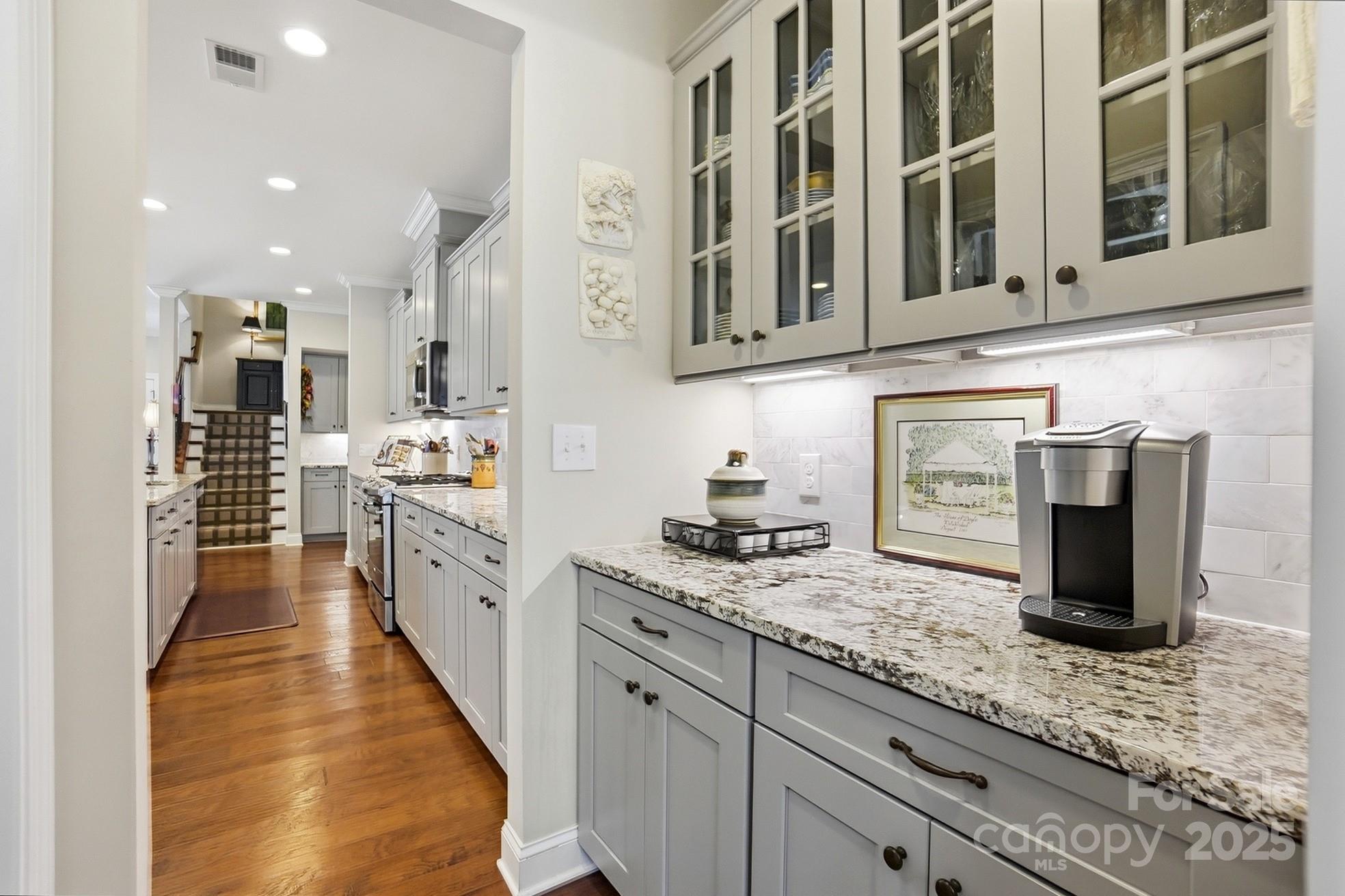 4069 Henshaw Road Waxhaw, NC 28173 - Photo 18 of 48 a kitchen with stainless steel appliances kitchen island granite countertop a stove and a sink