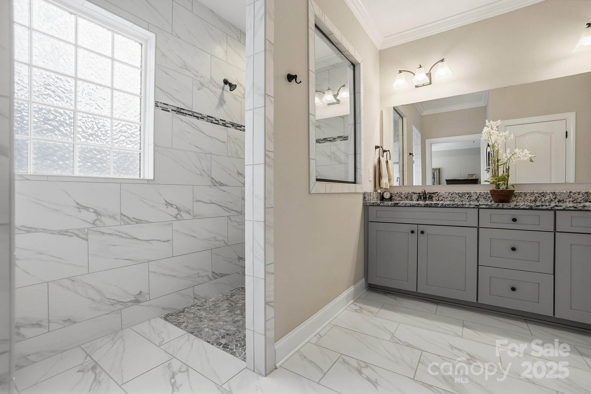 4069 Henshaw Road Waxhaw, NC 28173 - Photo 24 of 48 a spacious bathroom with a granite countertop sink a mirror and a