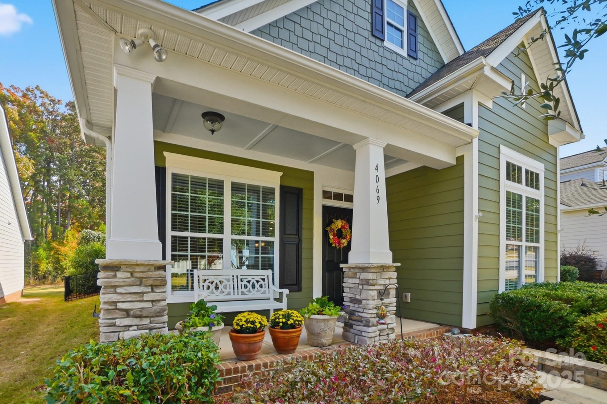 4069 Henshaw Road Waxhaw, NC 28173 - Photo 3 of 48 front view of a house with a large window and potted plants