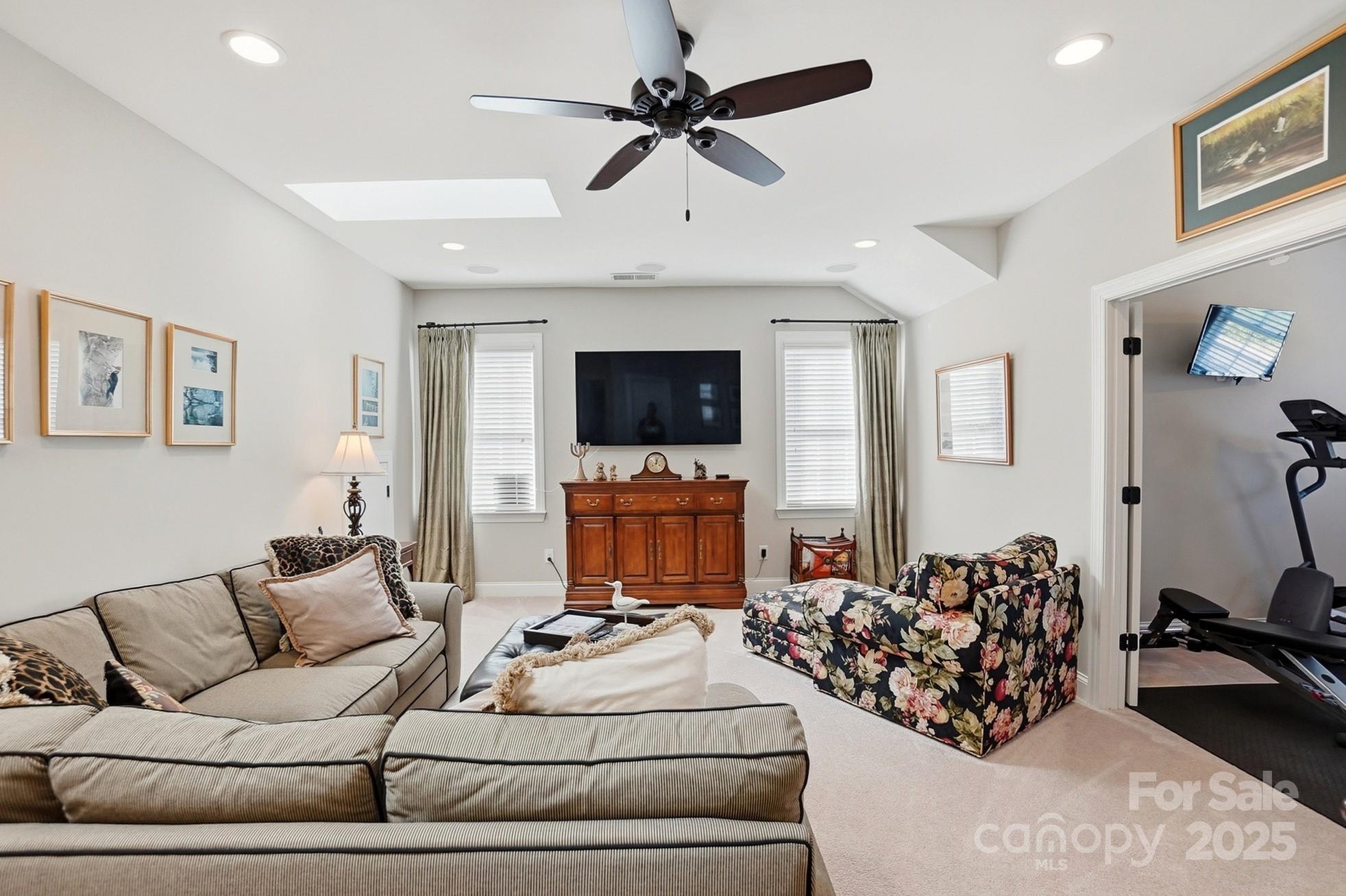 4069 Henshaw Road Waxhaw, NC 28173 - Photo 35 of 48 a living room with furniture flat screen tv and a ceiling fan