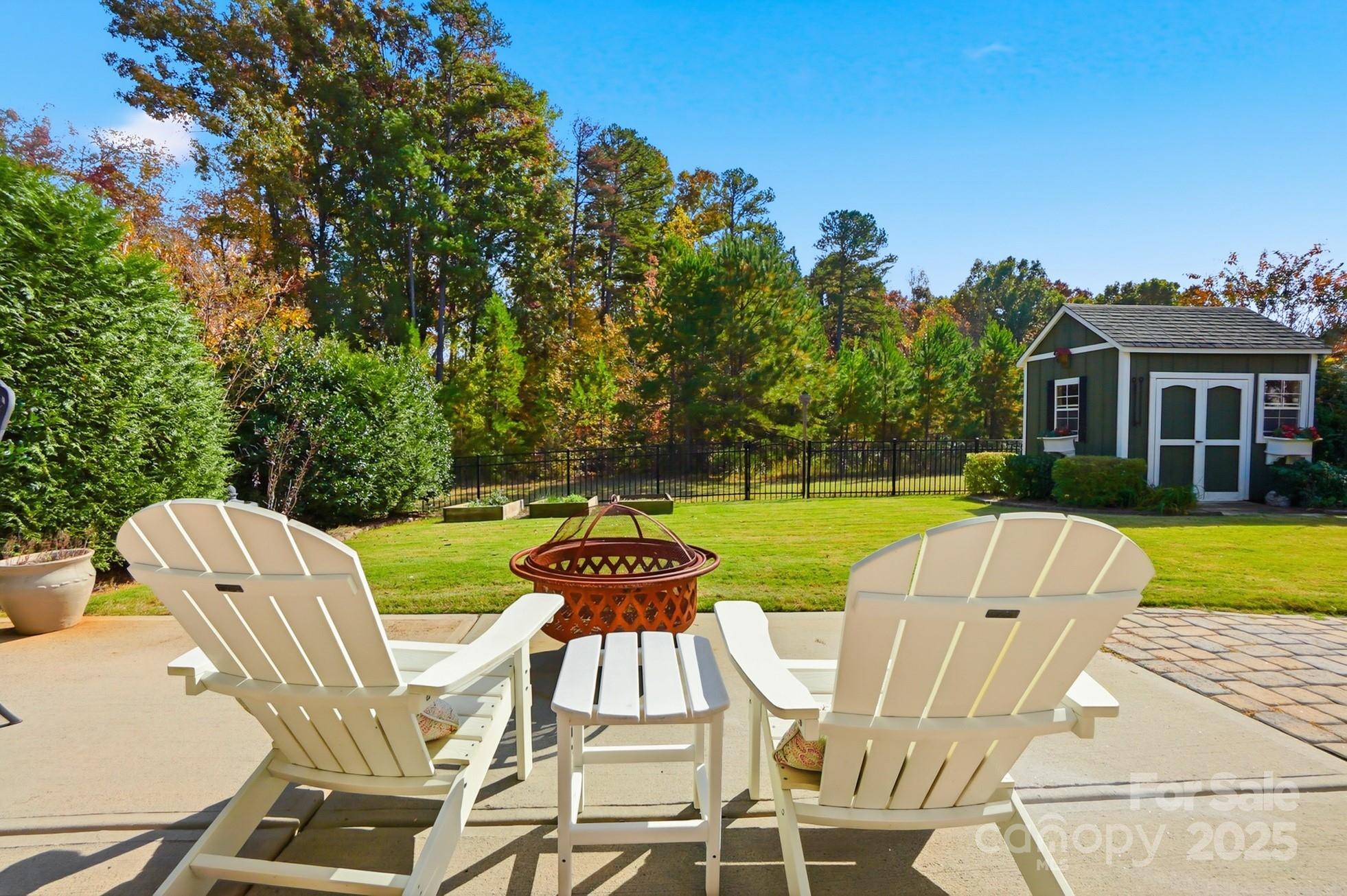4069 Henshaw Road Waxhaw, NC 28173 - Photo 42 of 48 a view of a chairs and table in patio with a yard