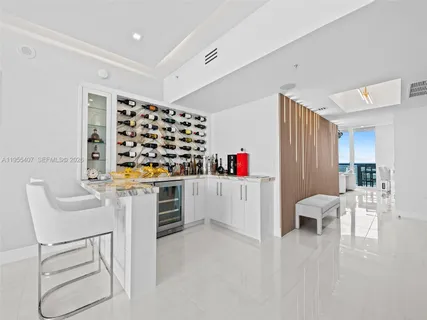 a bedroom with a bed a flat screen tv and a fireplace