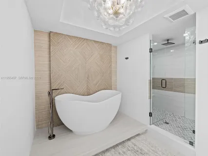 a bathroom with a sink mirror and shower