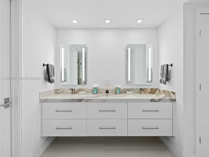 a living room with furniture a lamp and a potted plant