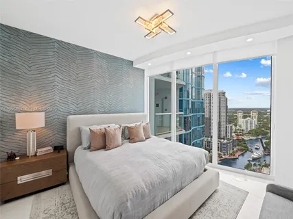a living room with furniture and floor to ceiling windows
