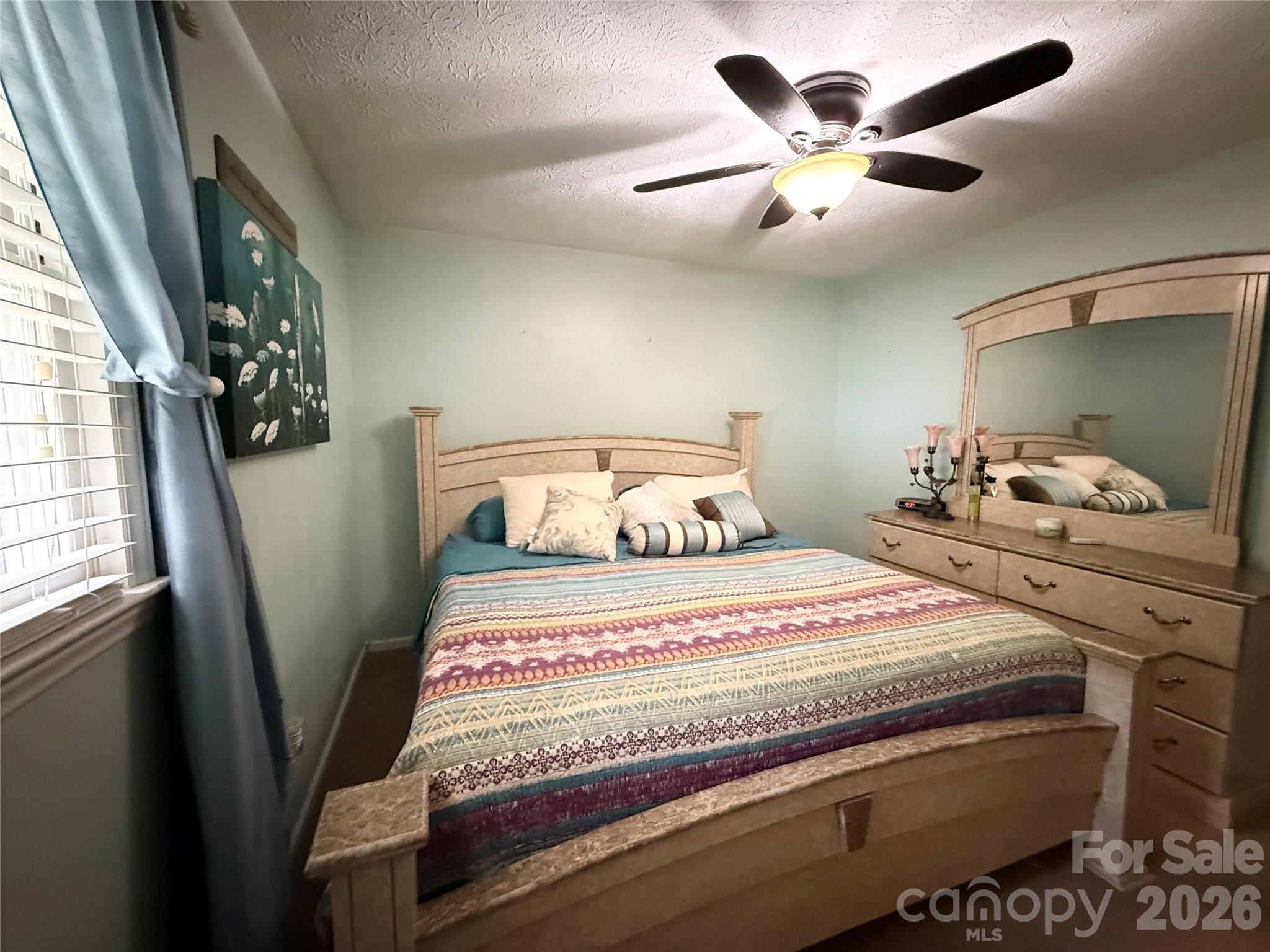 580 Legion Road Lenoir, NC 28645 - Photo 10 of 22 a bedroom with a bed and a large window