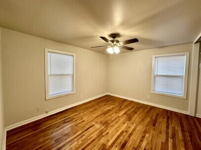 4214 37th Street Lubbock, TX 79413 - Photo 11 of 14 a view of an empty room with a window and wooden floor