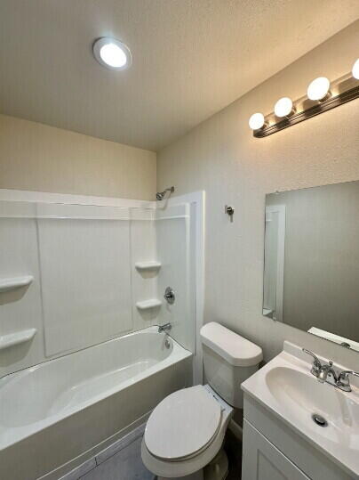 4214 37th Street Lubbock, TX 79413 - Photo 12 of 14 a bathroom with a sink a toilet and shower