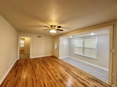 4214 37th Street Lubbock, TX 79413 - Photo 3 of 14 a view of empty room with wooden floor and fan
