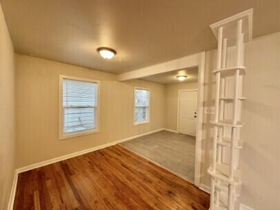 4214 37th Street Lubbock, TX 79413 - Photo 4 of 14 a view of an empty room with wooden floor and a window