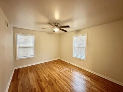 4214 37th Street Lubbock, TX 79413 - Photo 7 of 14 wooden floor in an empty room with a window