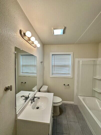 4214 37th Street Lubbock, TX 79413 - Photo 8 of 14 a bathroom with a sink a toilet and shower