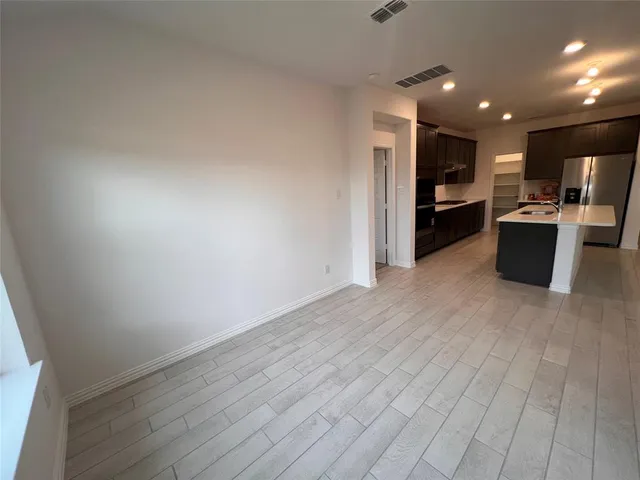 a view of kitchen with stainless steel appliances refrigerator and microwave