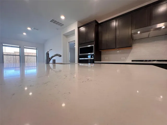 a view of a room with gym equipment and a large window