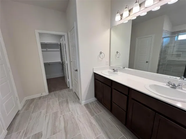 a bathroom with a sink vanity and a mirror