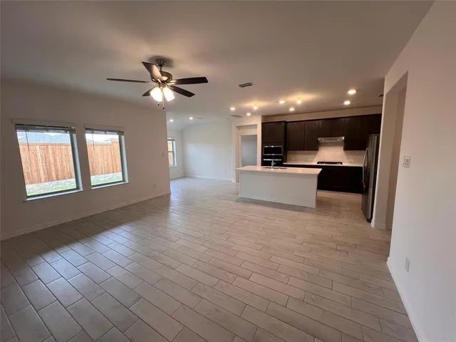 a view of kitchen with sink and microwave