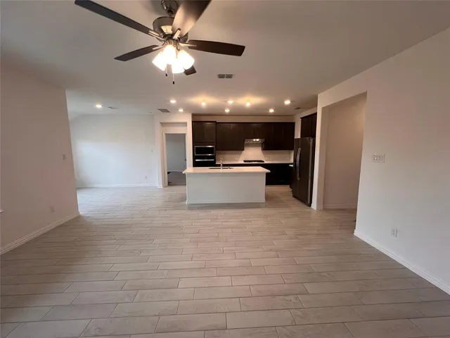 a view of a kitchen with a sink and a refrigerator