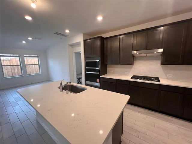 a kitchen with stainless steel appliances a refrigerator and a stove