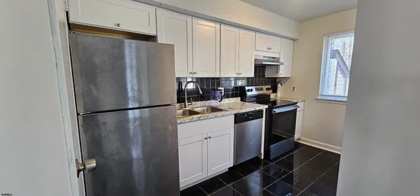 a kitchen with stainless steel appliances a refrigerator stove microwave and sink