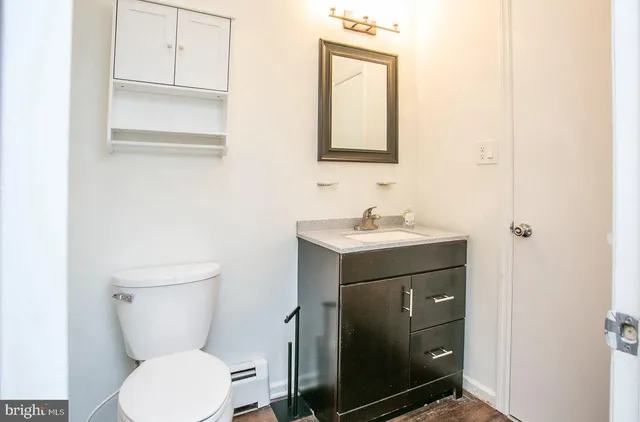 a bathroom with a toilet sink and mirror