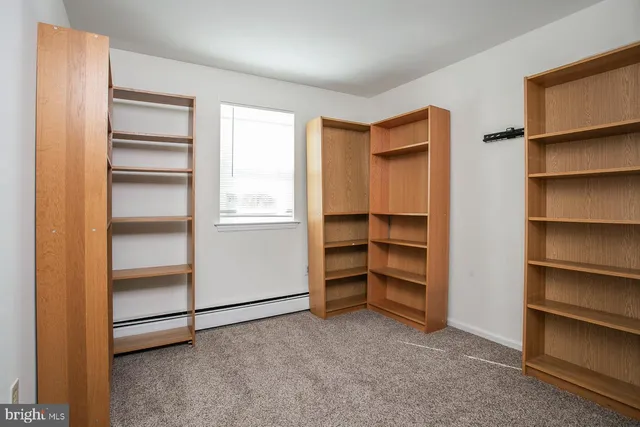 a view of an empty room with a closet