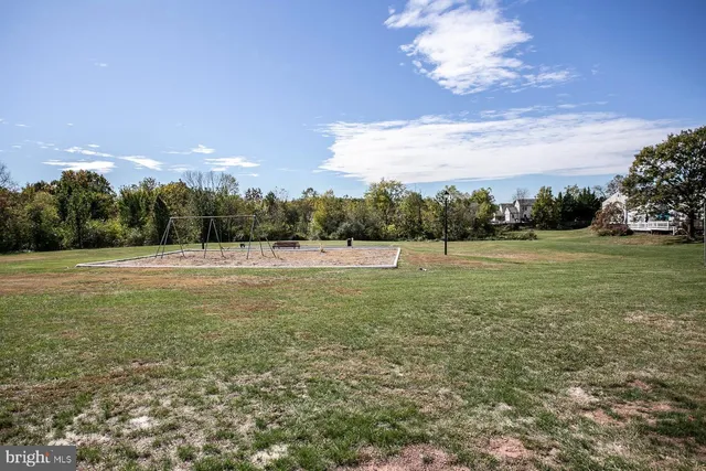 a view of a green field with sunset