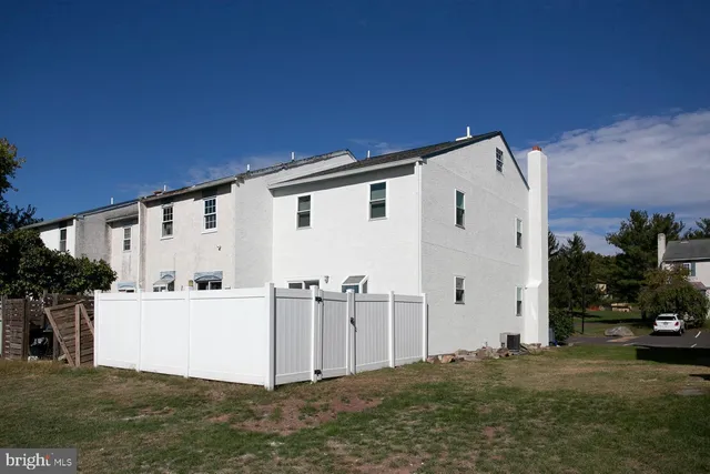 a view of a white house with a yard