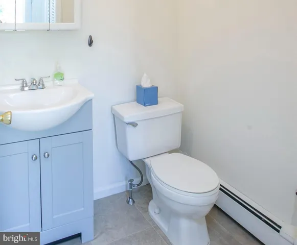 a white toilet sitting next to a bathroom sink