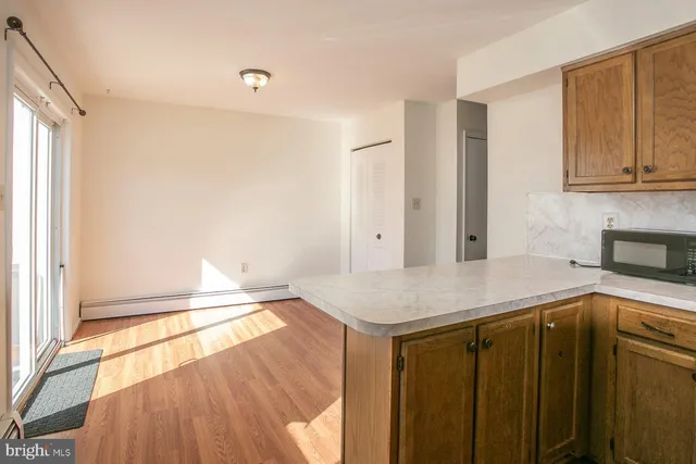 a kitchen with a sink a stove and cabinets
