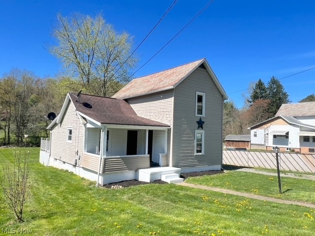 1918 Wainwright Road New Philadelphia, OH 44663 - Photo 21 of 24 Rear view of property with a lawn