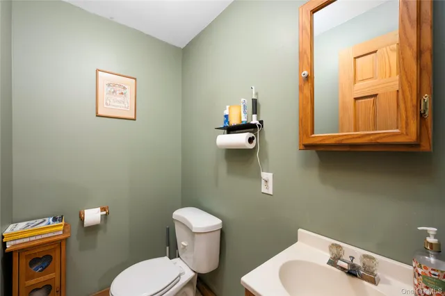 a white toilet sitting next to a bathroom sink