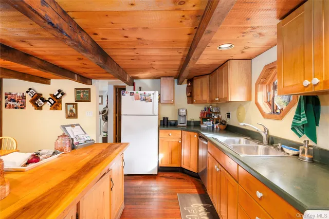 a kitchen with stainless steel appliances granite countertop a sink window and refrigerator