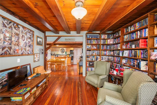 a living room with furniture and a book shelf