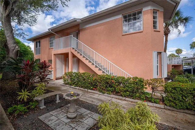 a view of a house with large space and a car park in front of it