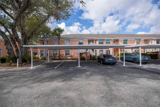 an aerial view of a house with swimming pool and outdoor seating