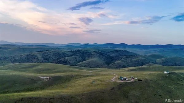 a view of a field with an ocean