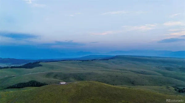 a view of a field with an ocean