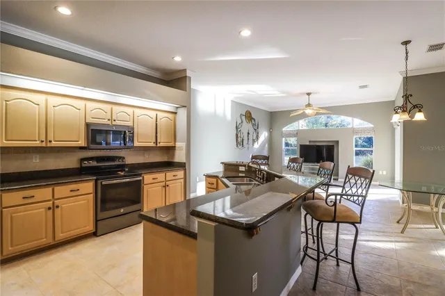 a kitchen with a sink stove and refrigerator