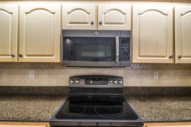 a living room with furniture a large window and a table