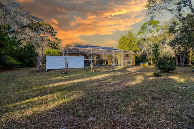 an aerial view of a house with a yard and garden