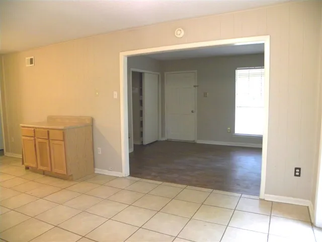 a view of a hallway to rooms