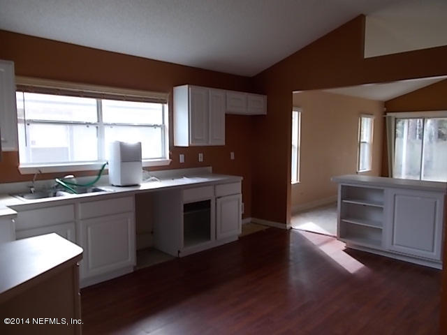 938 Cherry Point Way Jacksonville, FL 32218 - Photo 9 of 34 a kitchen with granite countertop a stove and a sink