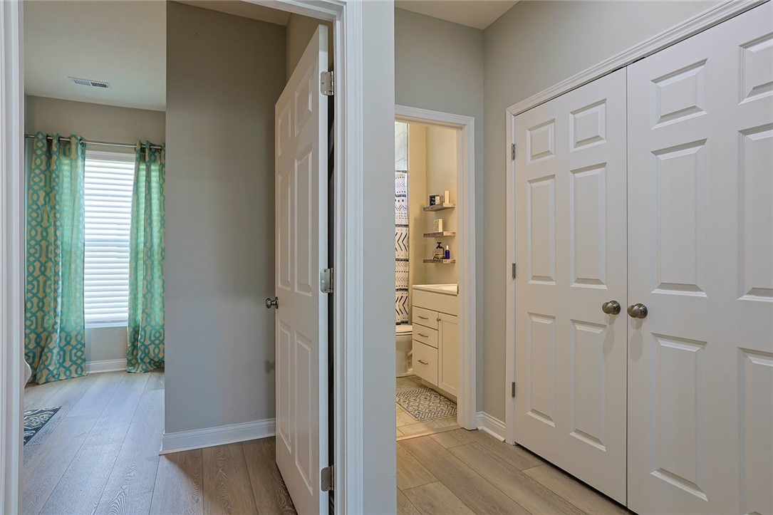 5013 Arena Court Hamilton, OH 45011 - Photo 37 of 41 This interior hallway features warm flooring and convenient storage leading to adjacent rooms.