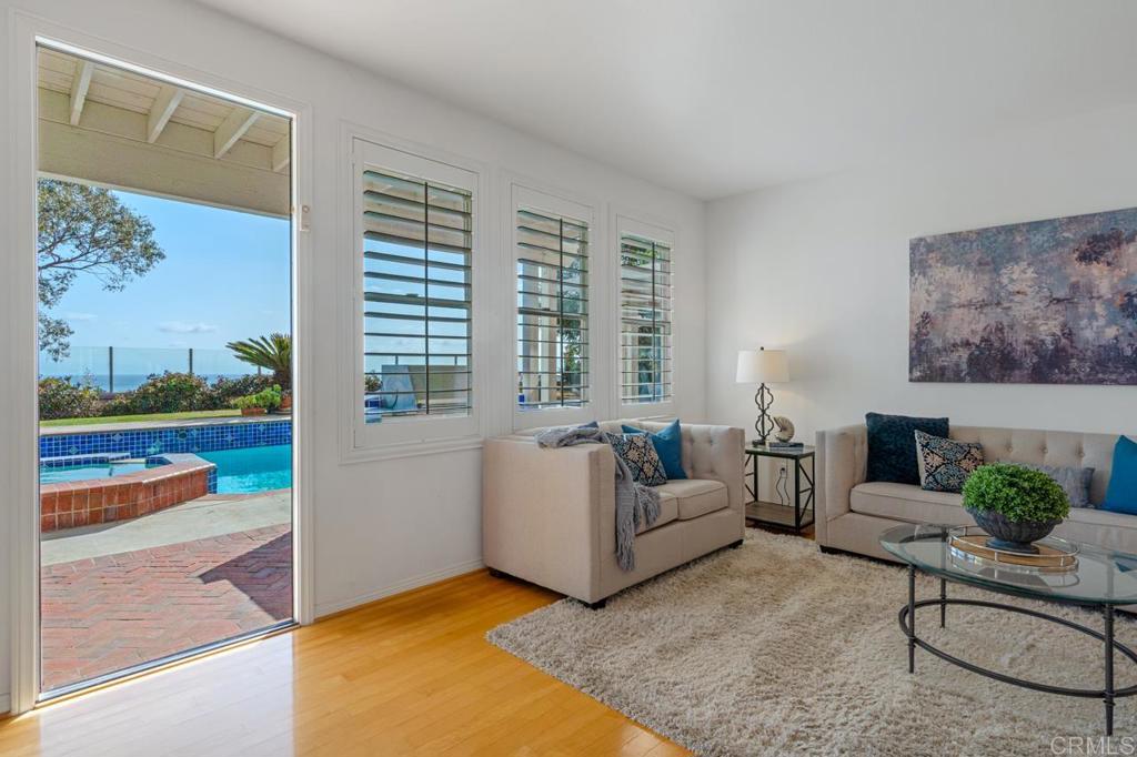 7357 Melodia Terrace Carlsbad, CA 92011 - Photo 29 of 60 a living room with furniture and a floor to ceiling window