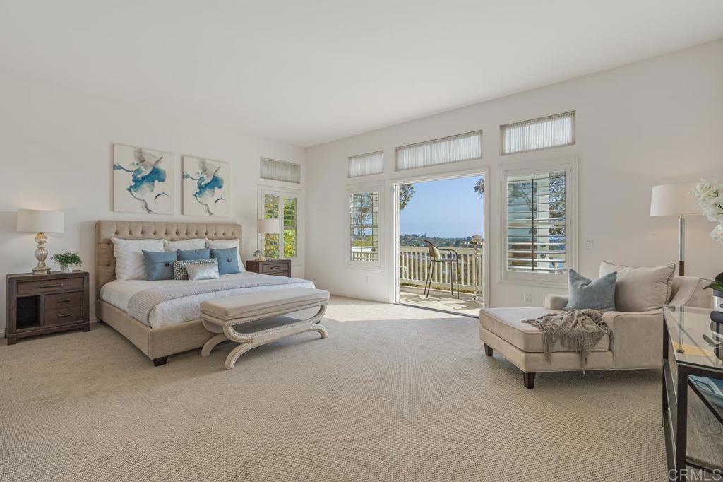 7357 Melodia Terrace Carlsbad, CA 92011 - Photo 35 of 60 a spacious bedroom with a bed and a couch