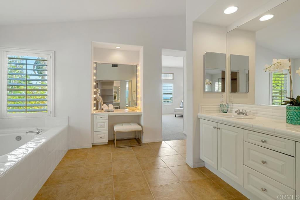 7357 Melodia Terrace Carlsbad, CA 92011 - Photo 41 of 60 a spacious bathroom with a double vanity sink a mirror and a bathtub