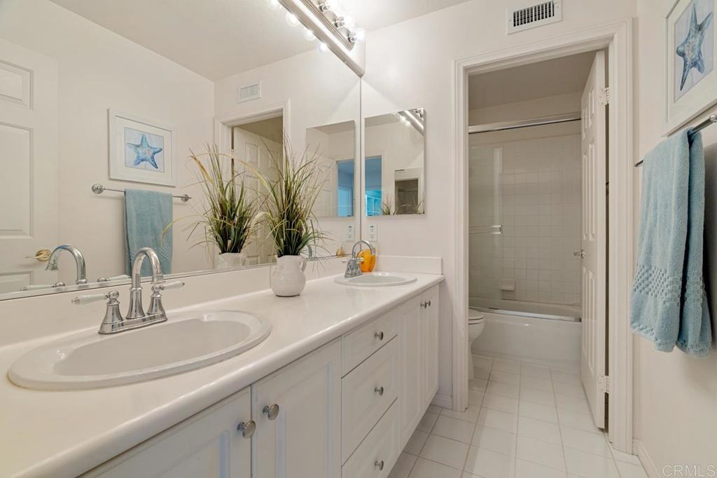 7357 Melodia Terrace Carlsbad, CA 92011 - Photo 44 of 60 a bathroom with a sink and a mirror