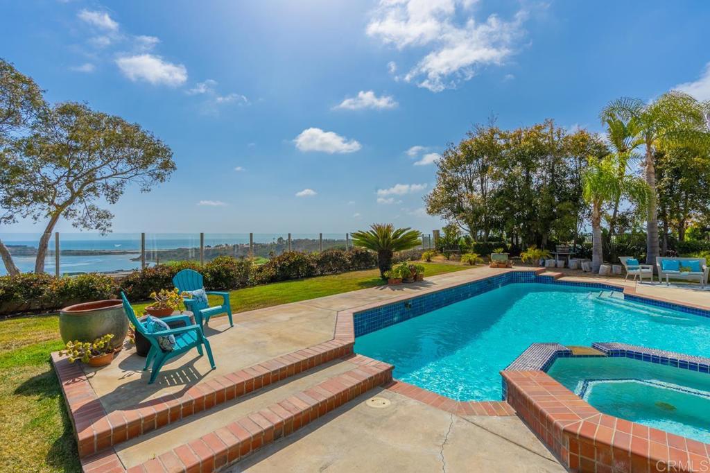 7357 Melodia Terrace Carlsbad, CA 92011 - Photo 50 of 60 a view of a swimming pool with a lounge chairs