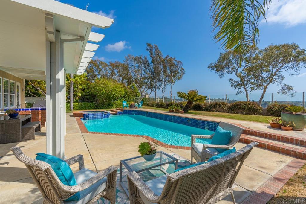 7357 Melodia Terrace Carlsbad, CA 92011 - Photo 51 of 60 a view of a chairs and table in patio with swimming pool