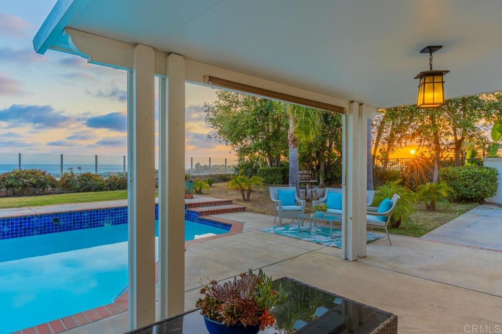 7357 Melodia Terrace Carlsbad, CA 92011 - Photo 52 of 60 a living room filled with furniture and a floor to ceiling window